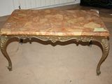 a marble top coffee table on a tile floor