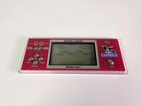 an image of a red gameboy sitting on top of a white table