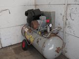 a small air compressor sitting in the corner of a room