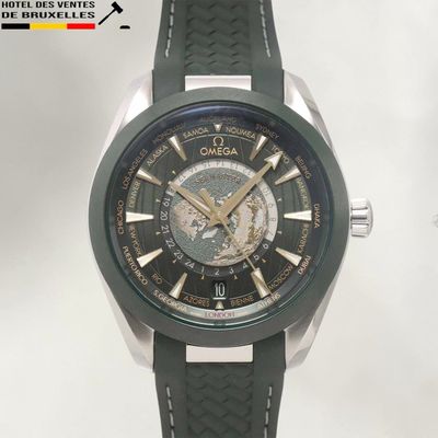 the watch is green and silver with a black face