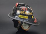 firefighters helmet on a mannequin head on a black background