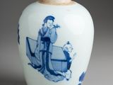 a blue and white vase with a man on a boat