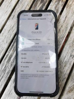 iphone xr with a broken screen sitting on a wooden table
