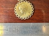 a close up of a ruler with a coin on it