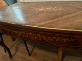 a wooden table with a wooden top and a blue chair