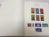 an open book with stamps on it on a table