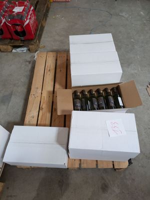 several boxes of wine are stacked on a pallet in a warehouse
