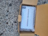 a box with a towel inside of it on the ground