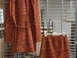 a coat and skirt on display in a room