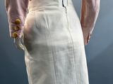an image of a mannequin wearing a pink shirt and white skirt