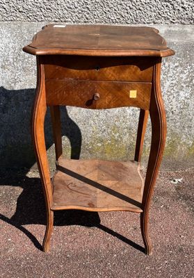 a small wooden table with a drawer on top of it