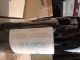 a bottle of wine that is sitting on top of a carton