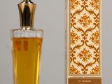 perfume bottle next to a box of perfume on a table