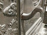 a close up of a metal door with a handle