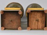pair of small wooden boxes with handles on a white surface