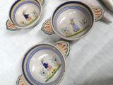 three bowls and spoons sitting on a table