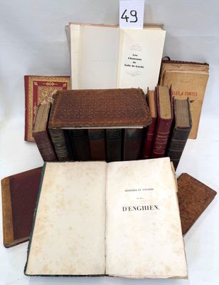 several old books are stacked on top of each other on a table