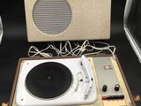 a white turntable with speakers and a speaker on top of it