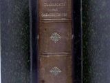 an old book opened to show the spines of a book