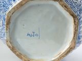a blue and white vase with writing on it