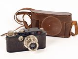 a camera and a case sitting next to each other on a white surface