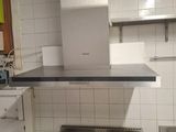 two stoves in a kitchen with a sink and a stove top