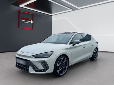 a white car is parked in a large room with a sign on the wall