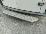 a close up of a metal step board on a vehicle