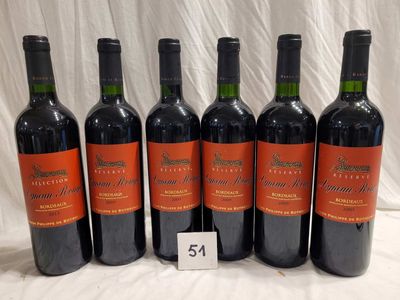 six bottles of red wine are lined up on a table