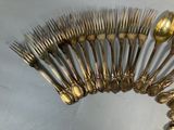 a lot of silver spoons and forks arranged in a circle