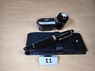 a pen and a wallet on a table next to an apple watch