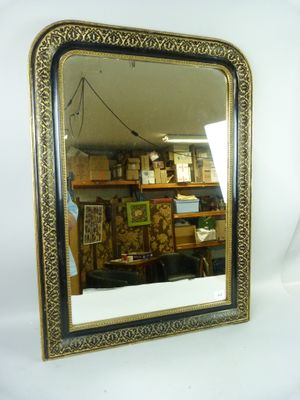 a mirror that is sitting on the wall next to a shelf