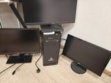 two monitors and a desktop computer sitting on the floor