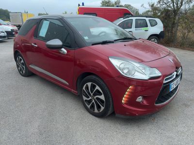the red car is parked in the parking lot next to other cars