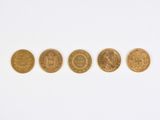 four different types of gold coins on a white surface