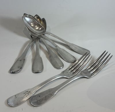 a lot of spoons and forks sitting on a table