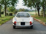 a white car that is driving down the road