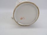 a close up of a coffee cup on a white surface