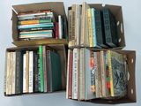 boxes of books are stacked on top of each other on a table