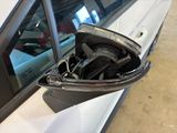 a close up of a car door handle with a bag in it