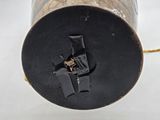 a black and gold lamp that is on a white table