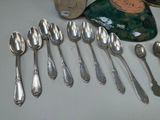 a lot of silver spoons and spoon spoons on a table