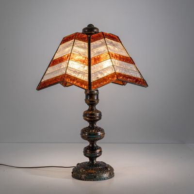 a close up of a lamp on a table with a white background