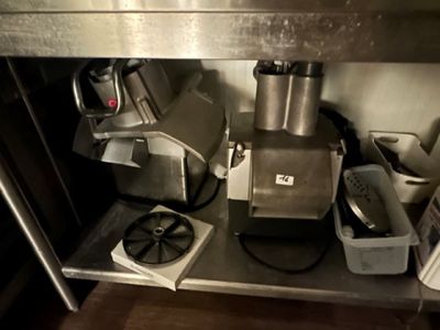 a metal shelf with a blender and other appliances on it