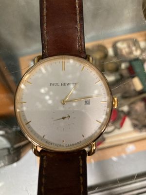 a close up of a watch on display in a glass case