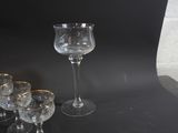 four wine glasses sitting on a table next to each other
