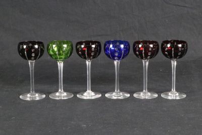 six wine glasses are lined up in a row on a black background