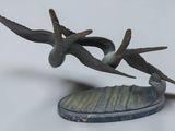 two birds that are sitting on a piece of metal