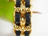 a gold watch with a blue face and a chain around it