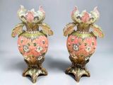 two vases that have been decorated with flowers on them